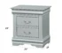 Elegant platinum finish nightstand with two drawers in a modern bedroom
