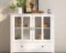 White glass door buffet cabinet with double glass doors and unique bell handle in dining room