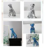 Boxer dog figurine on a desk with office accessories.