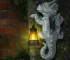 Solar dragon lantern glowing on a tree trunk at night, dragon figurine resin garden decor