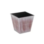 Square planter in brown and off-white tones placed on a stone patio, with small succulents planted inside.