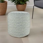 Goldoma 20-inch blue geometric pouf ottoman on a patio, showcasing its round shape and polyester fabric