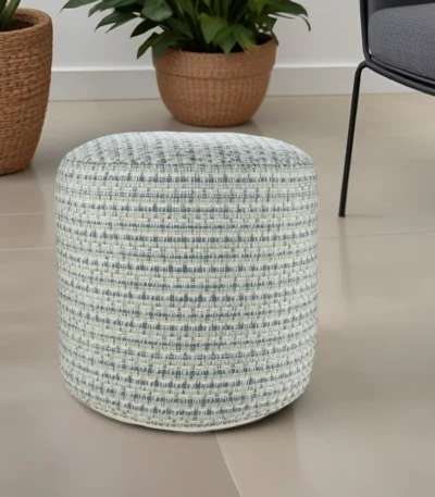 Goldoma 20-inch blue geometric pouf ottoman on a patio, showcasing its round shape and polyester fabric