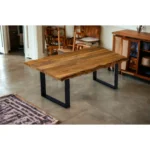 63-inch solid wood dining table with black sled base and brown top in modern industrial style from Goldoma