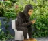 Sasquatch toilet statue sitting on a toilet in a garden setting