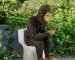 Sasquatch toilet statue sitting on a toilet in a garden setting
