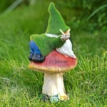 Flocked gnome statue with solar light features, set against a stone wall with ivy in background.
