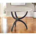 Goldoma 40 inch round marble dining table with black metal three-leg base in a modern dining room setting