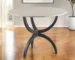 Round marble dining table with black metal base in a cozy dining room setting