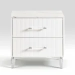 White two-drawer nightstand with faux marble top and chrome legs in a modern bedroom setting