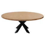 Rustic round dining table with natural acacia wood top and black iron pedestal base in a farmhouse dining room