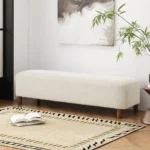 Modern upholstered ottoman bench with wood legs in neutral tones, perfect for seating or decor