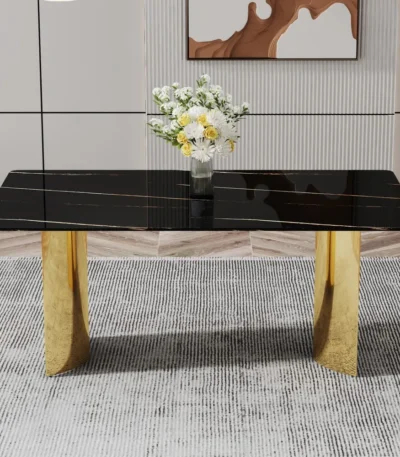 Modern dining table with black patterned glass top and gold metal legs in a stylish dining room