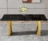 Modern black glass dining table with gold metal legs in a stylish dining room setting