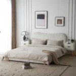 Goldoma plush upholstered king bed with wavy headboard and vertical stitching in white boucle fabric