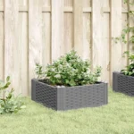 Large garden planter in light grey polypropylene with green plants on patio