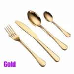 Elegant gold flatware set with fork, knife, and spoon on a white tablecloth