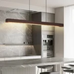 Close-up of the adjustable chandelier showing the round canopy and three hanging lamps with clear glass shades.