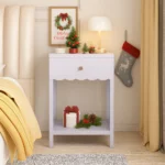 Modern nightstand with scalloped edge drawer and open shelf in lilac color, placed beside a bed