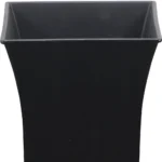Black square planter with a small succulent plant on a modern dining table, natural light from window