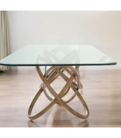 Modern 94-inch clear glass dining table with solid wood pedestal base in a bright dining room