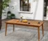 Modern acacia wood dining table with six chairs on a patio