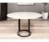 48" round marble dining table with white marble top and black metal pedestal base in a modern dining room