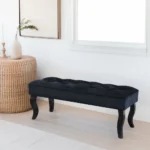 Mid-century velvet ottoman with wood legs in black - Goldoma