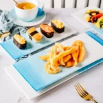 Nordic gradient blue ceramic dessert plates set with bowls and cups on a wooden table