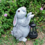 Side view of the outdoor bunny decoration on a patio table, with warm glow from its chest.