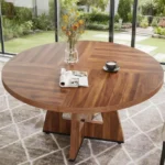 Modern round dining table with marble top and wood legs seating six in a living room