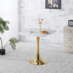 Modern square dining table with marble top and gold metal base in a small apartment dining room