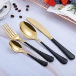 Elegant gold flatware set with fork, knife, and spoon on a white tablecloth