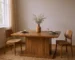 Brown wood extendable dining table with self-storing leaf and pedestal base in a modern dining room