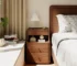 Solid walnut nightstand with three drawers in a modern bedroom