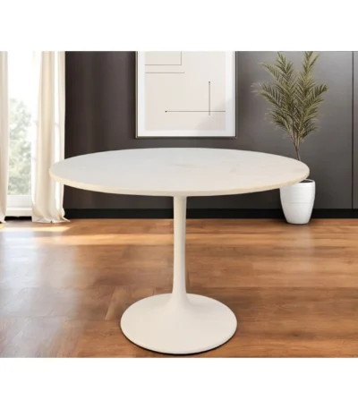 White marble round dining table 40 inch with iron pedestal base in a modern dining room setting