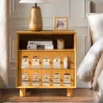 Two drawer nightstand with mirrored front and open shelf in natural wood finish, minimalist design for bedroom storage