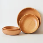 Natural wooden salad bowl with fresh greens and cherry tomatoes