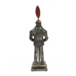 Armor suit positioned in a home office corner, next to a potted plant and lamp, emphasizing its decorative scale and