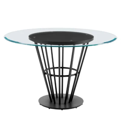 Round glass dining table with black iron pedestal base in a modern dining room setting