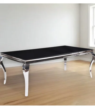Black and white glass dining table with stainless steel base in modern home