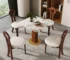 Modern square dining table for 4 with sintered stone top and black metal base in a bright dining room