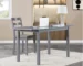 Dark gray extendable dining table extended to seat eight, with chairs in a modern dining room
