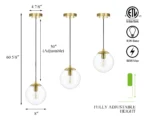 Pendant light in a kitchen island setting, with brass stem and clear glass ball glowing.