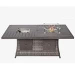 Gray wicker outdoor gas fire pit table with ice bucket and glass wind guard on patio