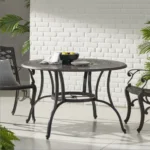 Goldoma Outdoor Cast Aluminum Circular Dining Table in Bronze with lattice design and umbrella hole