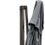Dark gray rectangular tilt cantilever patio umbrella with stand in outdoor setting