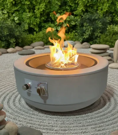 Galvanized steel outdoor fire pit with natural gas flame on a patio