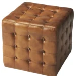 Goldoma brown tufted faux leather cube ottoman as footrest and extra seat in living room