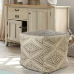 Goldoma 20-inch beige cotton tribal pouf ottoman with tufted stitching used as foot rest in living room